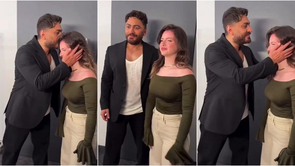 تامر حسني يقبل رأس فتاة بكواليس حفلته.. تعرف على هويتها