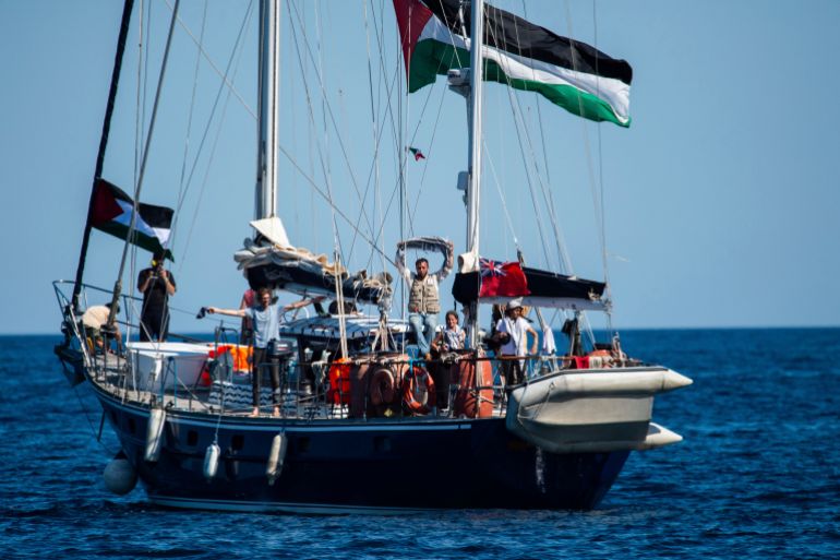 Activists of the Freedom Flotilla Coalition, board the Madleen boat, ahead of setting sail for Gaza, departing from the Sicilian port of Catania, Italy, Sunday, June 1, 2025. (AP Photo/Salvatore Cavalli)