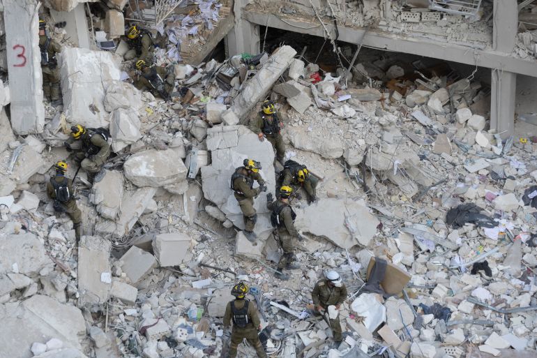 BAT YAM, ISRAEL - JUNE 15: Emergency and rescue soldiers search for trapped people around heavily damaged buildings after an overnight missile strike from Iran on June 15, 2025 in Bat Yam Israel. Iran launched a retaliatory missile strike on Israel starting late on June 13, after a series of Israeli airstrikes earlier in the day targeted Iranian military and nuclear sites, as well as top military officials. (Photo by Amir Levy/Getty Images)