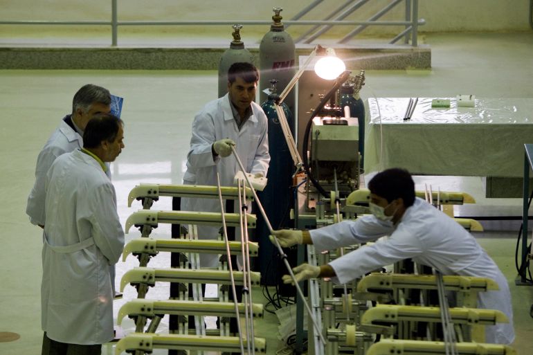 Workers move a fuels rod at the Fuel Manufacturing plant at the Isfahan Uranium Conversion Facility 440 Km (273 miles) south of Tehran April 9, 2009. REUTERS/Caren Firouz (IRAN POLITICS ENERGY)