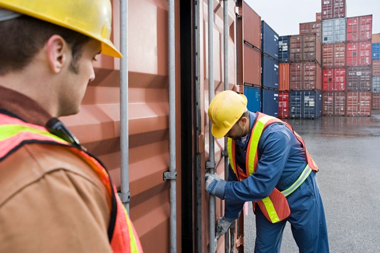 Men working at container terminal