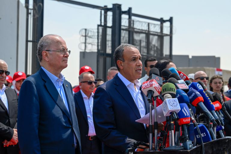 Palestinian prime minister Mohammad Mustafa (L) listens as Egypt's Foreign Minister Badr Abdelatty (C) speaks at a press conference on the Egyptian side of the Rafah border crossing in Rafah on August 18, 2025.