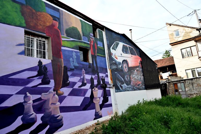 A photo shows the facades of old buildings renovated with murals by Bosnian street artist Benjamin Cengic and his creative team in Sarajevo on May 22, 2025. (Photo by ELVIS BARUKCIC / AFP)