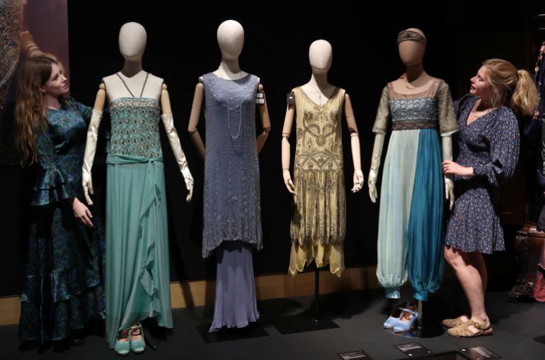 Gallery assistants pose with costumes worn by actors in the tv series Downton Abbey, during a press preview for the Downton Abbey farewell exhibition and auction of props, costumes, and set pieces at Bonhams in London, Britain, August 18, 2025. REUTERS/Hannah McKay