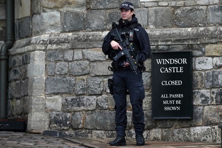 An armed police officer stands guard at the entrance to Windsor Castle ahead of the arrival of President Donald Trump in Windsor, England, Wednesday, Sept. 17, 2025.(AP Photo/Alastair Grant)