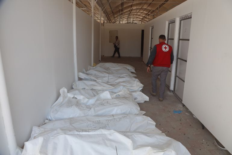 KHAN YUNIS, GAZA - OCTOBER 18: International Committee of the Red Cross (ICRC) teams receive the bodies of Palestinians detained by Israel in Gaza and hand over them to officials of the Palestinian Ministry of Health under the cease-fire and hostage-prisoner exchange agreement between Israel and Hamas, at a designated location near Nasser Hospital in Khan Yunis, Gaza on October 18, 2025. (Photo by Abdallah F.s. Alattar/Anadolu via Getty Images)