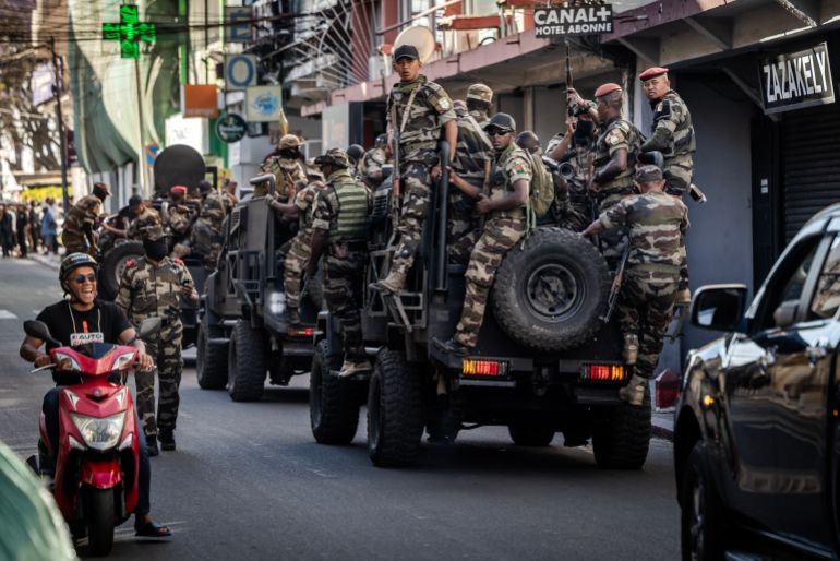 Members of Madagascar’s Army CAPSAT unit ride on armoured vehicles as they head to the Presidential Palace in Antananarivo, October 14, 2025.
