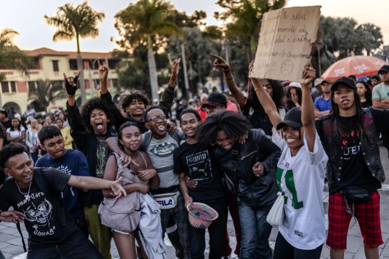 Young residents hold banners and dance to rock music during a concert as crowds gather for a civil society rally demanding President Rajoelina’s resignation, following the announcement by Madagascar’s Army CAPSAT unit that they would assume power in the country in Antananarivo, October 14, 2025.