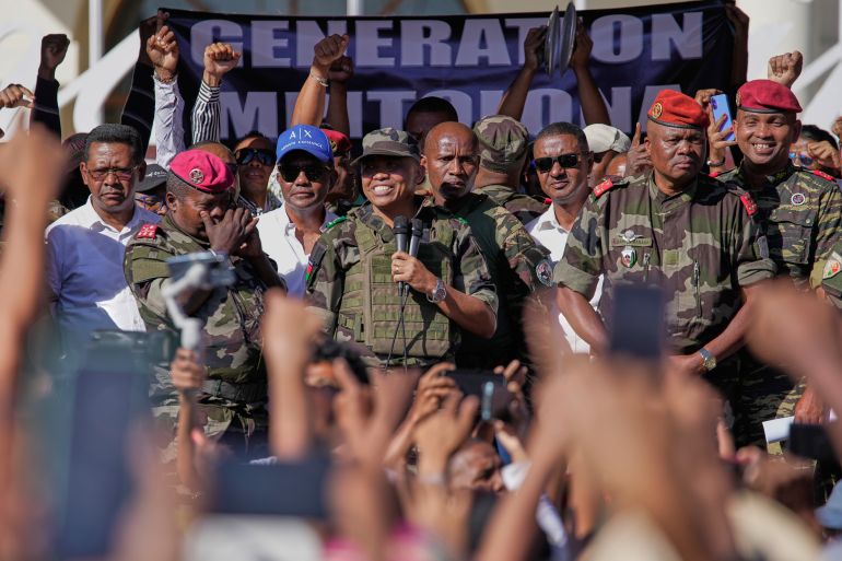 CAPSAT military unit commander Col. Michael Randrianirina announces to protesters that the armed forces are taking control of the country in Antananarivo, Madagascar, Tuesday, Oct. 14, 2025. (AP Photo/Brian Inganga)