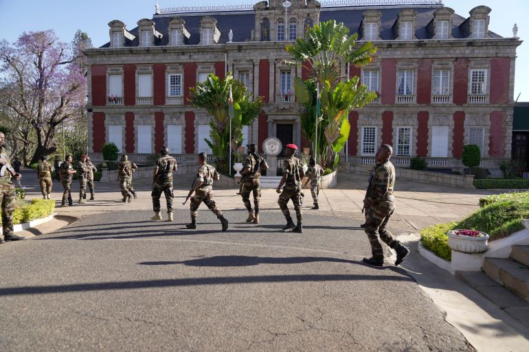 Troops loyal to CAPSAT military unit commander Col. Michael Randrianirina arrive at the presidency to announce that the armed forces are taking control of the country in Antananarivo, Madagascar, Tuesday, Oct. 14, 2025. (AP Photo/ Brian Inganga)