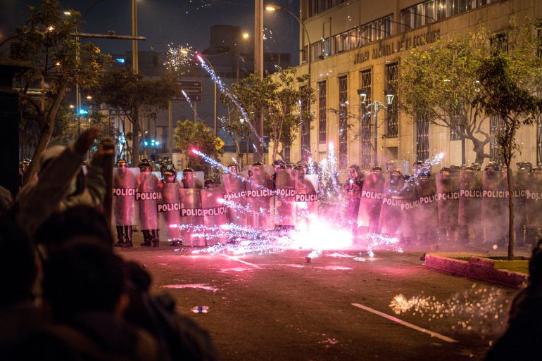 epa12457161 Peruvian police officers stand guard while blocking a flare near Congress during a demonstration against the new government of José Jeri in Lima, Peru, 15 October 2025. People are protesting against rising crime, economic insecurity, and corruption, a day after President Jose Jeri presented his cabinet. EPA/JOHN REYES MEJIA