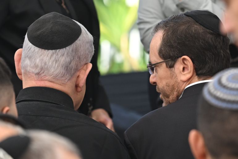 HERZLIYA, ISRAEL - DECEMBER 8: Israeli Prime Minister Benjamin Netanyahu (L) and Israel President Isaac Herzog (R) attend the funeral for First Sergeant Major Gal Meir Eisenkot, 25 years old, at the Herzliya cemetery on December 8, 2023 in Herzliya, Israel. The Israel Defense Forces said the 25-year-old major, son of the cabinet minister and former army chief Gadi Eisenkot, died on Thursday in Gaza. Over two months have passed since the Oct. 7 attacks by Hamas that sparked a retaliatory ground and air campaign by Israel in Gaza. (Photo by Alexi J. Rosenfeld/Getty Images)