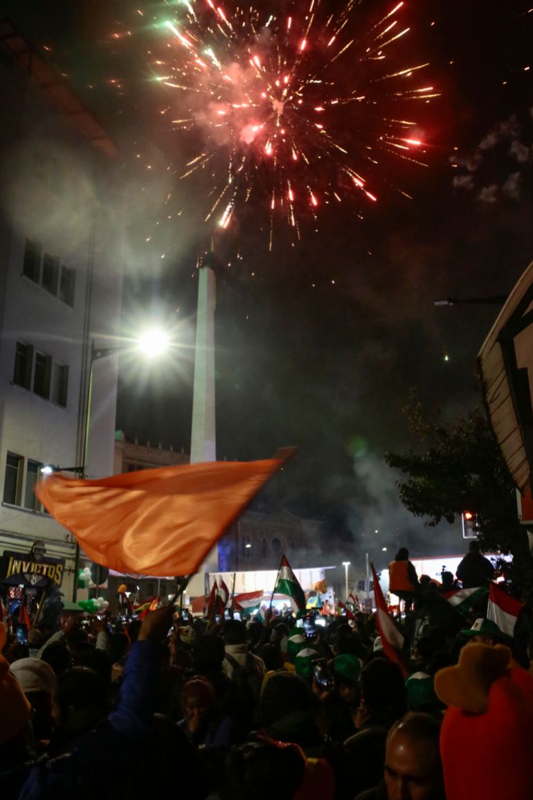 LA PAZ, BOLIVIA - OCTOBER 19: People gather to celebrate as fireworks light the sky at the obelisk following the presidential run-off on October 19, 2025 in La Paz, Bolivia. Presidential Candidate Rodrigo Paz of the Christian Democratic Party (PDC) is set to become Bolivia's President with 54.6% of the votes and after almost 98% of ballots counted in the electoral court’s preliminary tally; Jorge 'Tuto' Quiroga, has received 45.4%. Bolivians headed to the polls amid an important economic crisis, fuel shortage, and an increase in prices. (Photo by Gaston Brito Miserocchi/Getty Images)
