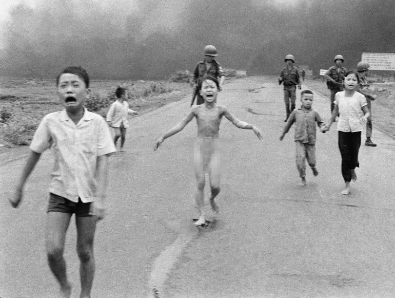 Vietnam Napalm 1972 South Vietnamese forces follow after terrified children, including 9-year-old Kim Phuc, center, as they run down Route 1 near Trang Bang after an aerial napalm attack on suspected Viet Cong hiding places on June 8, 1972. A South Vietnamese plane accidentally dropped its flaming napalm on South Vietnamese troops and civilians. The terrified girl had ripped off her burning clothes while fleeing. The children from left to right are: Phan Thanh Tam, younger brother of Kim Phuc, who lost an eye, Phan Thanh Phouc, youngest brother of Kim Phuc, Kim Phuc, and Kim's cousins Ho Van Bon, and Ho Thi Ting. Behind them are soldiers of the Vietnam Army 25th Division. (AP Photo/Nick Ut)