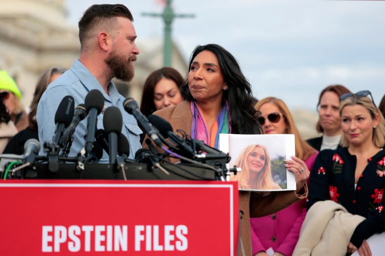 WASHINGTON, DC - NOVEMBER 18: Sky Roberts (L), brother of Virginia Giuffre, who was abused by Jeffrey Epstein, and his wife Amanda Roberts hold up a photo of Giuffre as they speak during a news conference with lawmakers on the Epstein Files Transparency Act outside the U.S. Capitol on November 18, 2025 in Washington, DC. Virginia Giuffre died by suicide in April 2025. The House is expected to vote today on the legislation, which instructs the U.S. Department of Justice to release all files related to the late accused sex trafficker Jeffrey Epstein. Heather Diehl/Getty Images/AFP (Photo by Heather Diehl / GETTY IMAGES NORTH AMERICA / Getty Images via AFP)