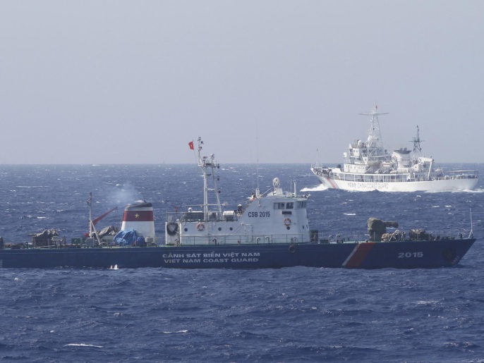 A ship (top) of the Chinese Coast Guard is seen near a ship of the Vietnam Marine Guard in the South China Sea, off shore of Vietnam in this May 14, 2014 file photo. The United States and India have held talks about conducting joint naval patrols that a U.S. defence official said could include the disputed South China Sea, a move that would likely anger Beijing, which claims most of the waterway. To match Exclusive SOUTHCHINASEA-INDIA/USA REUTERS/Nguyen Minh/Files