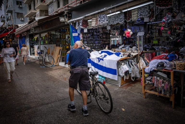 People walk through Tel Aviv’s Carmel Market, partially closed following ongoing missile attacks from Iran, June 23, 2025
