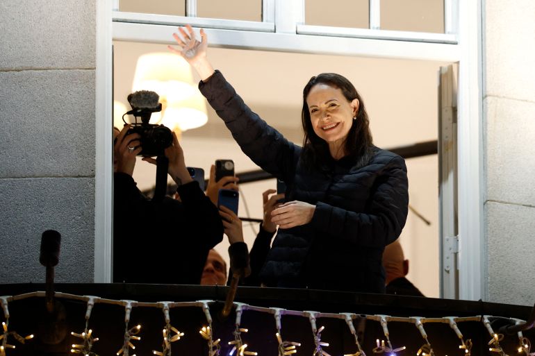 TOPSHOT - Nobel peace laureate Maria Corina Machado greets supporters from a balcony of the Grand Hotel in Oslo, Norway, early on December 11, 2025.