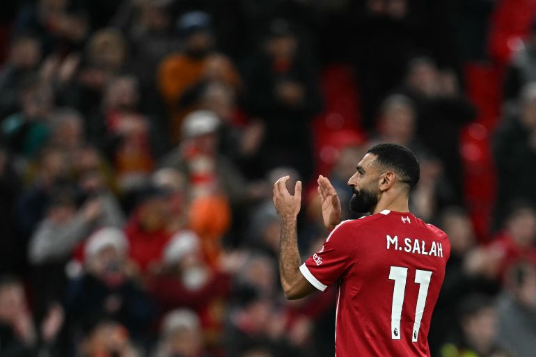 Liverpool's Egyptian striker #11 Mohamed Salah applauds the fans following the English Premier League football match between Liverpool and Brighton and Hove Albion at Anfield in Liverpool, north west England on December 13, 2025.