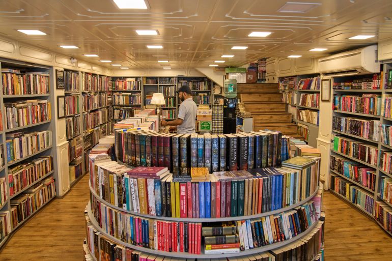 A Kashmiri man arranges books in a bookstore in Srinagar, Indian controlled Kashmir, Thursday, Aug. 7, 2025. (AP Photo/ Dar Yasin )