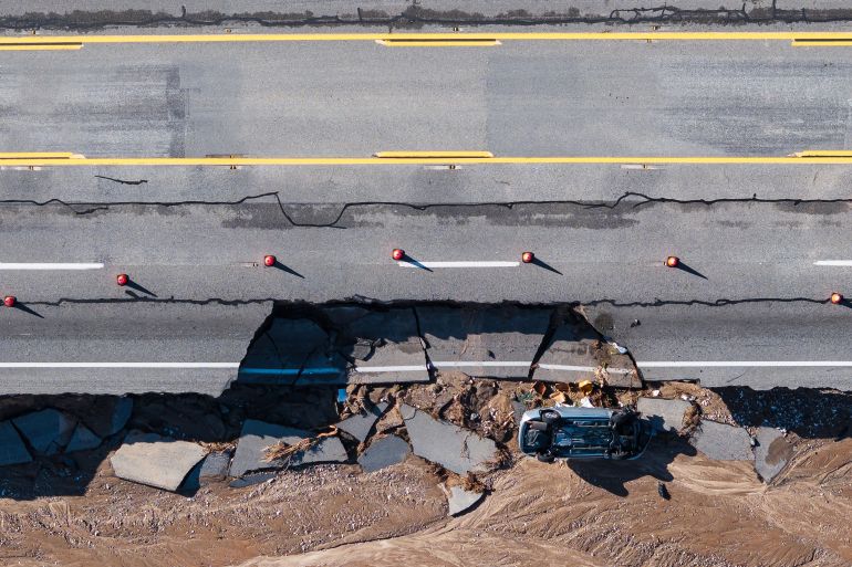 An aerial view shows damage to highway 138 after a series of storms on Thursday, Dec. 25, 2025, near Phelan, Calif. (AP Photo/William Liang)