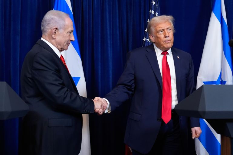 President Donald Trump shakes hands with Israel's Prime Minister Benjamin Netanyahu as he listens to a question from a reporter at the end of a news conference at Mar-a-Lago, Monday, Dec. 29, 2025, in Palm Beach, Fla. (AP Photo/Alex Brandon)