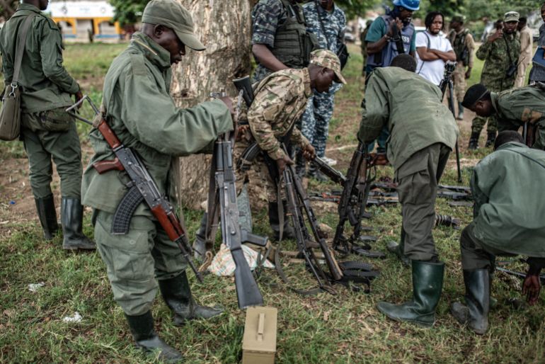 UVIRA, DEMOCRATIC REPUBLIC OF CONGO - DECEMBER 15: Members of the Rwanda-backed M23 rebel group inspect weapons surrender by Wazalendo militants on December 15, 2025 in Uvira, Democratic Republic of Congo. Fifty-two members from the coalition of Congolese and Burundian militias known as the Wazalendo joined M23 following the rebels' capture of the South Kivu city on December 10. Human Rights Watch has reported abuses perpetrated against civilians by fighters from both sides of the conflict during the offensive on Uvira, and has called for the safe passage and humanitarian assistance for those caught up in the fighting. (Photo by Daniel Buuma/Getty Images)