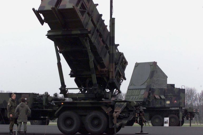German soldiers talk in front of a German Patriot missile launcher (L) and a tracking radar (R) during the multi-national excersise JPOW-4 in Peel, the Netherlands March 24. Joint Project Operation Windmill 4 (JPOW-4) is an international exercise in the tracking and destruction of ballistic missiles, cruise missiles and aircraft, in which Dutch, German, American, Danish, Luxembourg and Belgian units practise their Theater Missile Defence in a combined real and virtual theatre of operations. JPOW-4 is held from March 17 to March 25 in the Netherlands, Germany and Danmark.