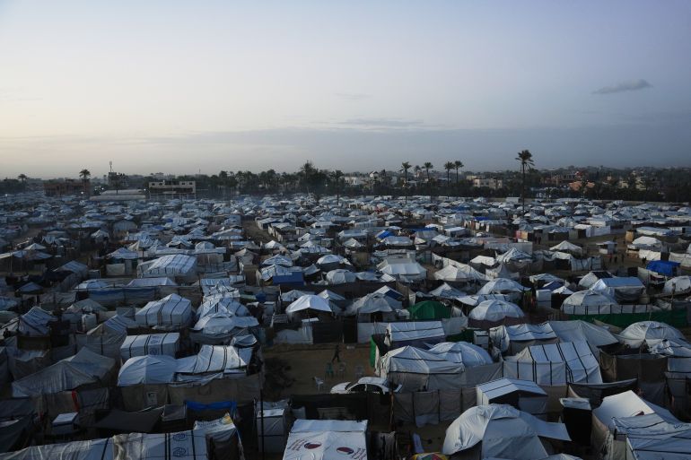 A tent camp for displaced Palestinians stretches across an area in Deir al-Balah, in the central Gaza Strip, Saturday, Jan. 10, 2026. (AP Photo/Abdel Kareem Hana)