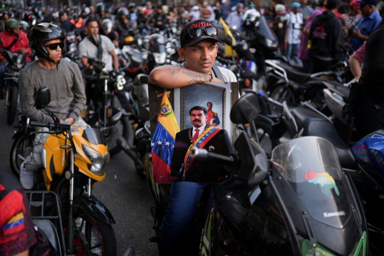Members of the militia group known as "Colectivos" take part in a march calling for the release of Venezuela's President Nicolas Maduro, after he and his wife Cilia Flores were captured following U.S. strikes on Venezuela, in Caracas, Venezuela, January 4, 2026. REUTERS/Gaby Oraa TPX IMAGES OF THE DAY