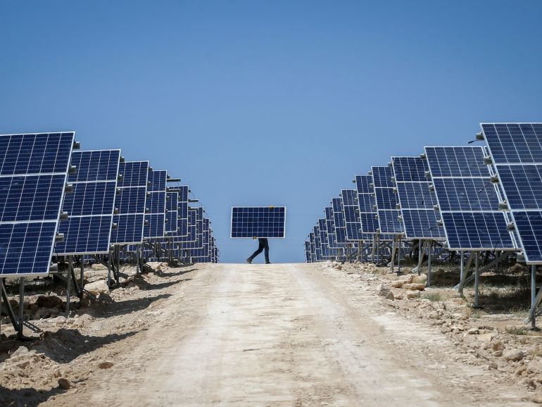 Solar power plant construction in Turkey's Van- - VAN, TURKEY - JULY 17 : A worker carries solar panel at the construction site of 20MW solar power plant projects of Akfen Renewable Energy in Edremit district of Van, Turkey on July 17, 2018. Akfen Renewable Energy company establishes two different solar power plants on an area covering 400 decares. Constructions of the 20 MW plants, with staff of 135, are expected to be completed in two months.