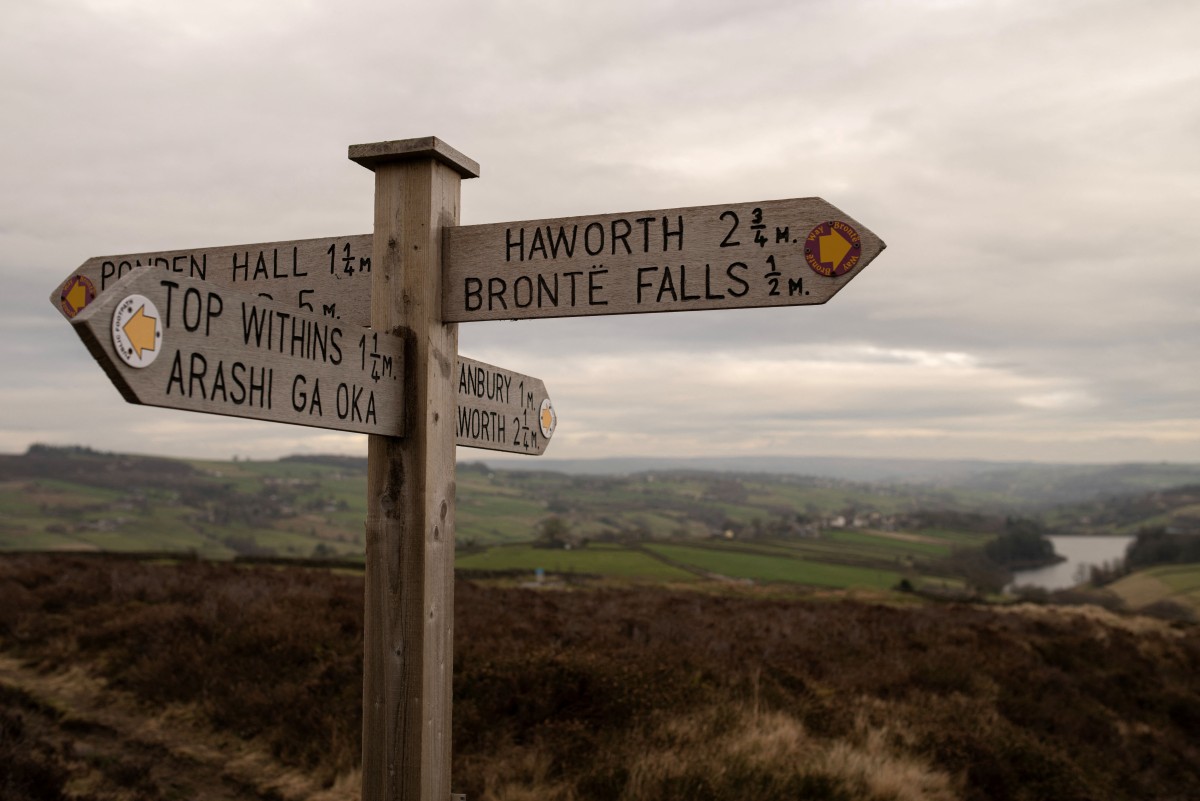 لوحة إرشادية تتضمن اللوحة عبارة مكتوبة باللفظ الياباني Arashi Ga Oka - أي مرتفعات وذرينغ - نظراً لتدفق السياح الكبير على الموقع. (أ ف ب)