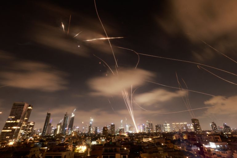 Israeli air defence systems are activated to intercept Iranian missiles over the Israeli city of Tel Aviv early on June 18, 2025.