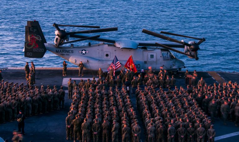 In this Aug. 9, 2017, photo released by the U.S. Navy, Marines of the 31st Marine Expeditionary Unit (MEU) and Sailors of the Bonhomme Richard Expeditionary Strike Group pay their respects to 1st Lt. Benjamin Cross, Cpl. Nathaniel Ordway and Pfc. Ruben Velasco during a sunset memorial aboard the amphibious assault ship USS Bonhomme Richard (LHD 6). The three Marines lost their lives when an MV-22 Osprey crashed off the coast of Queensland, Australia on Aug. 5. Various law enforcement agencies joined a procession Saturday, Aug. 26 for Velasco. (Mass Communication Specialist 2nd Class Jeanette Mullinax/U.S. Navy via AP)