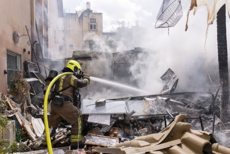 An Israeli firefighter works to put out a fire following Iranian missile strikes on Israel, amid the U.S.-Israel conflict with Iran, in Petah Tikva, Israel March 22, 2026. REUTERS/Itai Ron ISRAEL OUT. NO COMMERCIAL OR EDITORIAL SALES IN ISRAEL