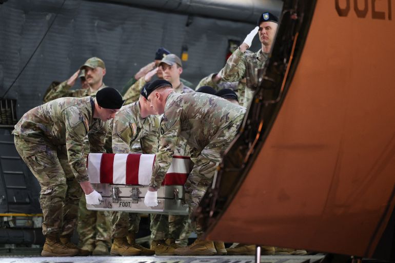 DOVER, DELAWARE - MARCH 09: A U.S. Army carry team moves a flag-draped transfer case containing the remains of Maj. Sorffly Davius, 46, of Cambria Heights, Queens, N.Y. at Dover Air Force Base on March 9, 2026 in Dover, Delaware. Davius died on March 6, 2026, in Camp Buehring, Kuwait, as a result of a non-combat related incident while supporting Operation Spartan Shield. Win McNamee/Getty Images/AFP (Photo by WIN MCNAMEE / GETTY IMAGES NORTH AMERICA / Getty Images via AFP)