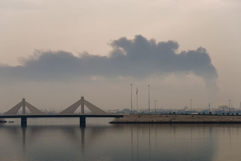 TOPSHOT - A plume of smoke rises after a reported Iranian strike on fuel tanks in Muharraq on March 12, 2026.