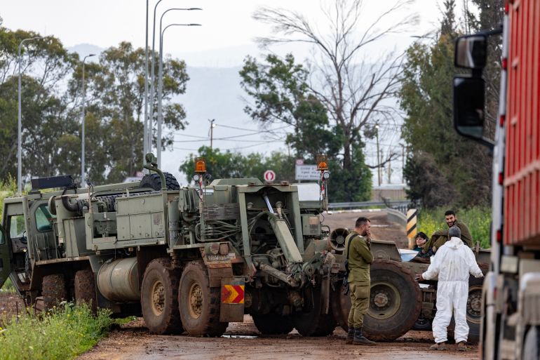 Israeli army soldiers are seen working near the border with Lebanon in the Upper Galilee in northern Israel on March 20, 2026.