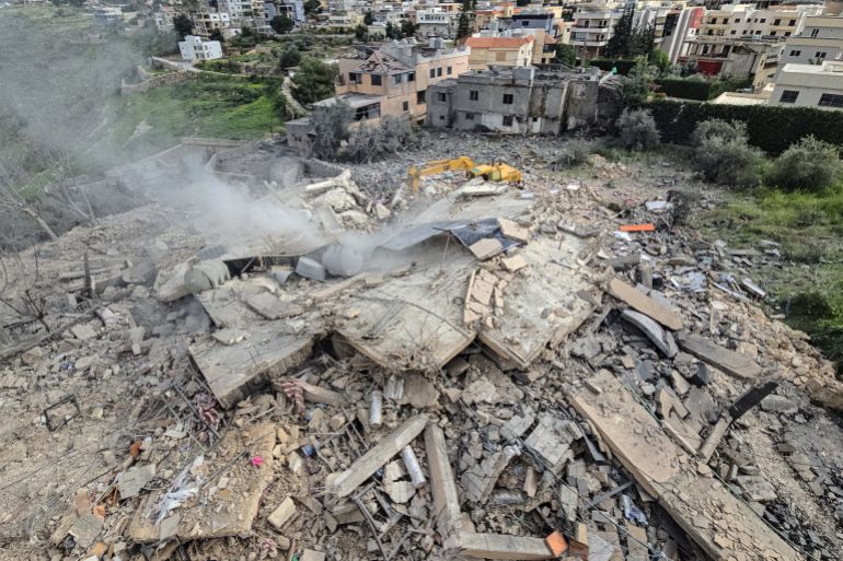 First responders work on the rubble of a building targeted by an Israeli airstrike in the southern Lebanese village of Hanouiyeh, east of Tyre, on March 30, 2026.