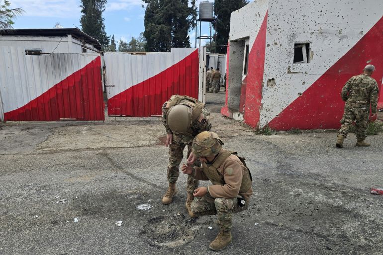 Lebanese army soldiers inspect the site of an Israeli airstrike that targeted their checkpoint in Aamriyeh, south of the coastal city of Tyre, on March 30, 2026.