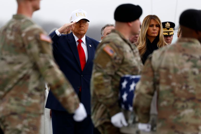 epa12802433 US President Donald Trump salutes as a US Army carry team moves a flag-draped transfer case containing the remains of Sergeant 1st Class Noah Tietjens during a dignified transfer of six fallen US service members at Dover Air Force Base in Dover, Delaware, USA, 07 March 2026. The remains of the soldiers from the 103rd Sustainment Command are being returned to the United States after they were killed in a drone attack in Kuwait. EPA/WILL OLIVER