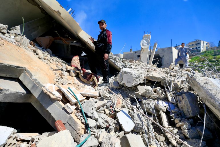 epa12803558 A man walks amongst the rubble of a building targeted in an Israeli airstrike in Sir el-Gharbiyeh, south Lebanon, 08 March 2026 leaving at least 17 people killed and 7 others injured. The Israeli military stated it is conducting strikes across the country targeting Hezbollah infrastructure and personnel. According to the Lebanese Ministry of Public Health, at least 394 people were killed and 1160 others injured in airstrikes across Beirut's southern suburbs and villages in southern Lebanon. EPA/STRINGER