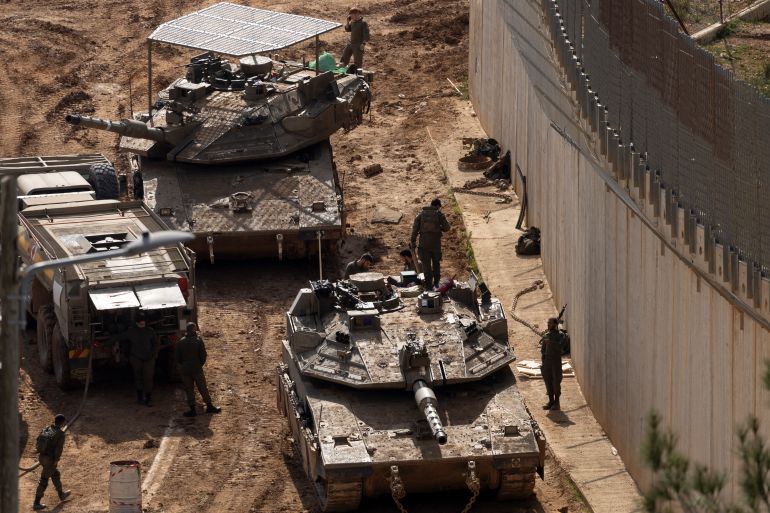 NORTHERN ISRAEL, ISRAEL - MARCH 4: Israeli soldiers stand alongside tanks near the border with Lebanon on March 4, 2026 in northern Israel. Hezbollah, the Iran-backed militant group in Lebanon, launched missiles at Israel in what it said was retaliation for the joint U.S.-Israeli war on Iran. (Photo by Amir Levy/Getty Images)