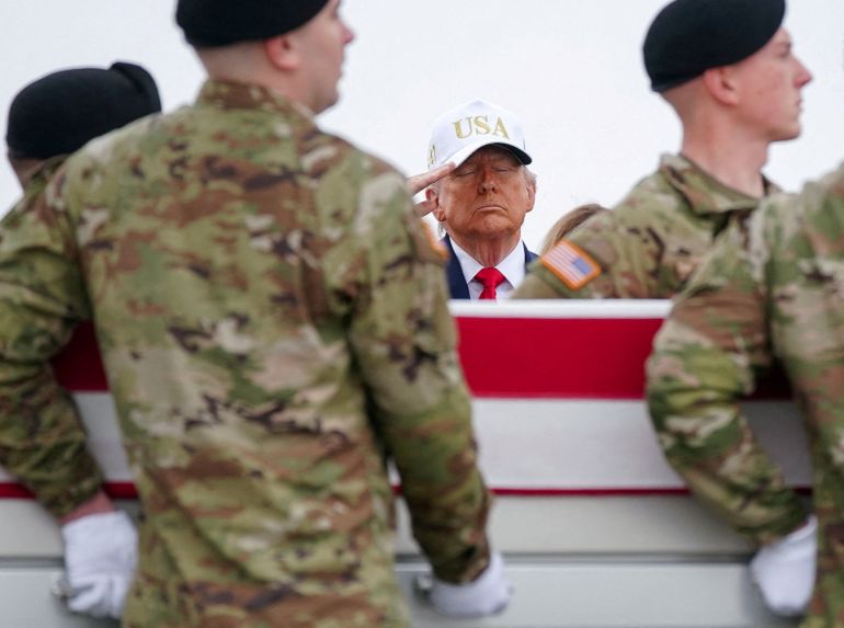 U.S. President Donald Trump salutes as members of the military carry a transfer case during a dignified transfer of the remains of six U.S. Army service members of the 103rd Sustainment Command, who were killed in Kuwait, Major Jeffrey O'Brien, Capitain Cody Khork, Chief Warrant Officer 3 Robert Marzan, Sergeant 1st Class Nicole Amor, Sergeant 1st Class Noah Tietjens and Sergeant Declan Coady, amid the U.S.-Israeli conflict with Iran, at Dover Air Force Base in Dover, Delaware, U.S., March 7, 2026. REUTERS/Nathan Howard TPX IMAGES OF THE DAY