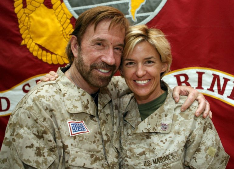 FILE PHOTO: Hollywood action star Chuck Norris (L) poses for a picture with Staff Sergeant Amy Forsythe during his visit to Camp Falluja, 50 km (30 miles) west of Baghdad in this November 2, 2006 file photo. Norris, known for his martial arts prowess and tough-guy image, has become a cult figure among the U.S. military in Iraq and an unlikely hero for some in Iraq's security forces. Picture taken November 2, 2006. REUTERS/Handout/U.S. military/File Photo FOR EDITORIAL USE ONLY. NOT FOR SALE FOR MARKETING OR ADVERTISING CAMPAIGNS. THIS IMAGE HAS BEEN SUPPLIED BY A THIRD PARTY
