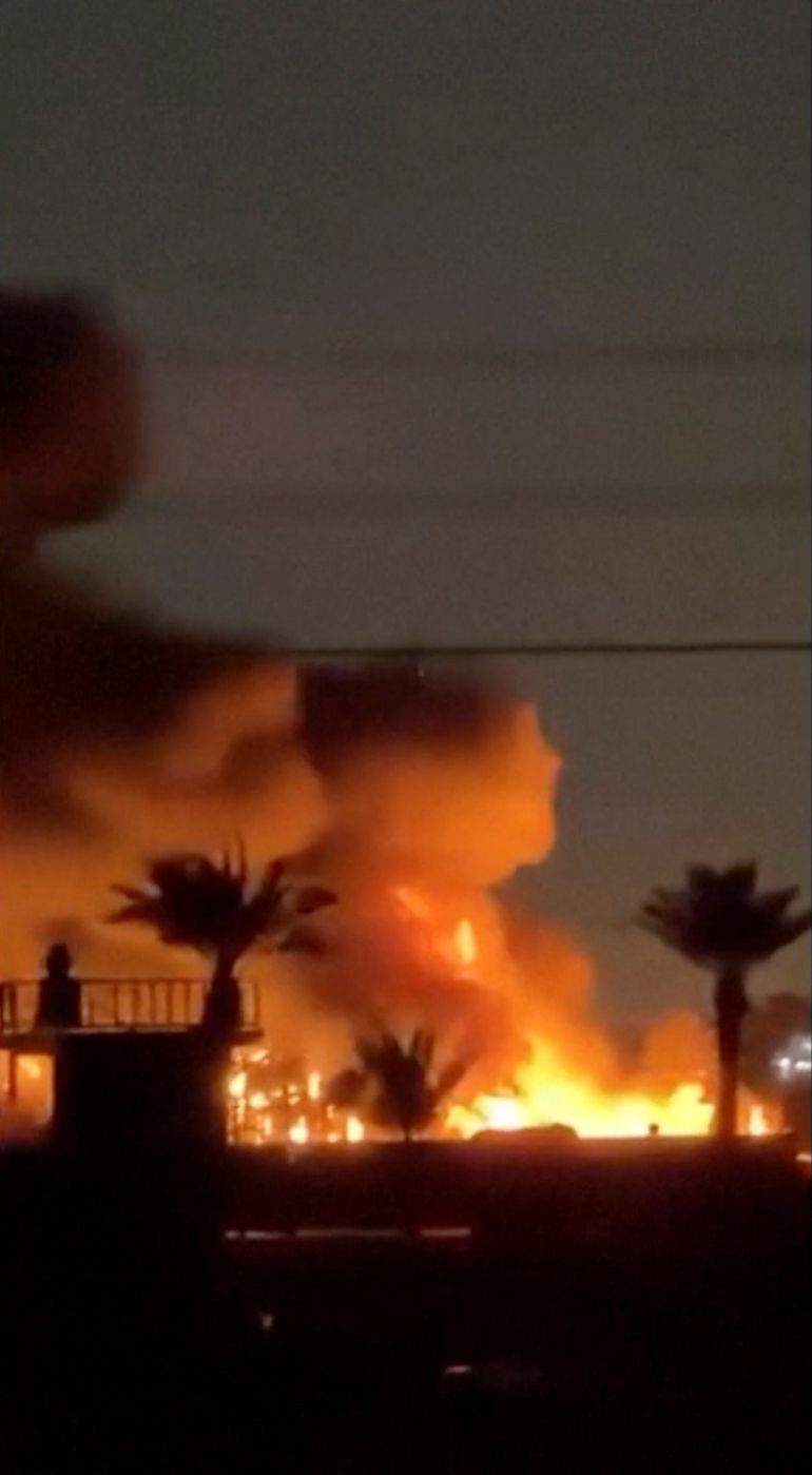 Fire and smoke plumes rise from a U.S. diplomatic facility near Baghdad airport, which the Iraqi security sources said was following drone attacks,in Baghdad, Iraq, in this screengrab obtained from a social media video released on March 20, 2026. Social Media/via REUTERS THIS IMAGE HAS BEEN SUPPLIED BY A THIRD PARTY. MANDATORY CREDIT. NO RESALES. NO ARCHIVES. VERIFICATION: Reuters was able to verify the location by the tower, buildings and vegetation that matched the file and satellite imagery of the area. The date when the video was filmed was not verified, however, on March 20 security sources told Reuters that a drone attack targeted the diplomatic facility of the United States near Iraq's Baghdad airport and a fire was reported. No old results of the video were found posted online before March 20.