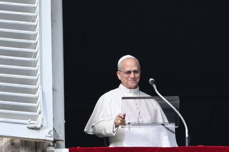 Pope Leo XIV addresses the crowd from the window of the apostolic palace overlooking St.Peter's square during his Sunday Angelus prayer at the Vatican on January 1, 2026. (Photo by Alberto PIZZOLI / AFP)