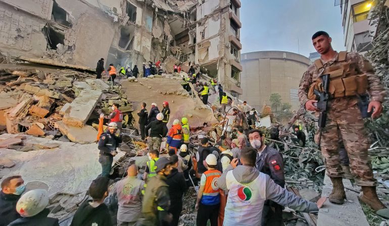 First responders and residents gather at the site of an Israeli airstrike in Beirut's Tallet al-Khayyat neighbourhood, on April 8, 2026.