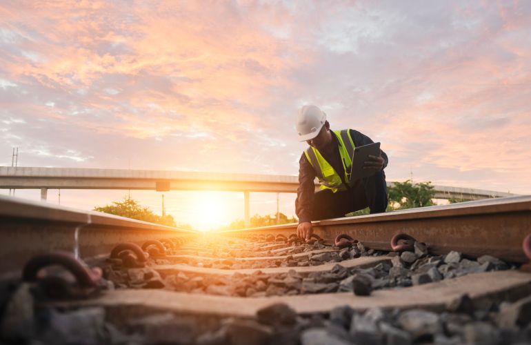 Asian engineer inspects trains Construction workers on the railway Engineer working on railway depot maintenance