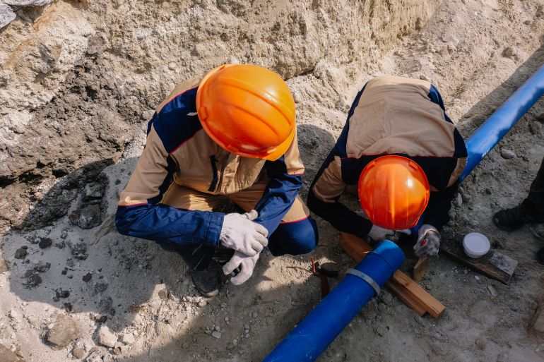 Workers are installing water supply pipeline system.